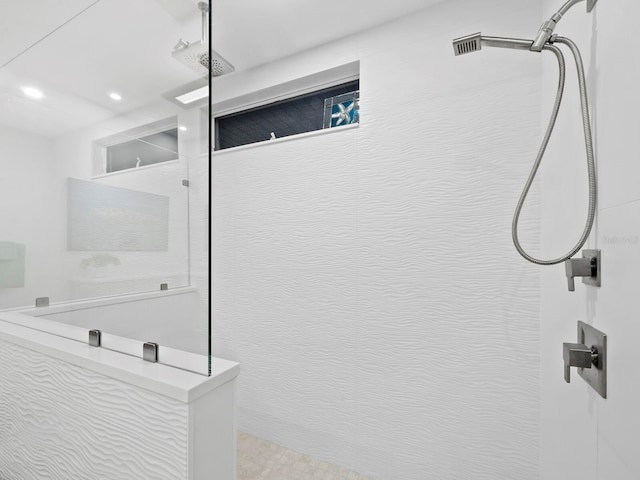 bathroom with a tile shower