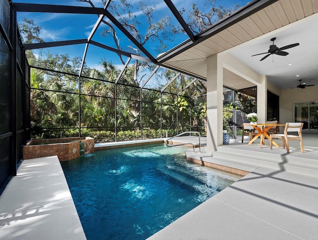 view of swimming pool with ceiling fan, a patio area, and glass enclosure