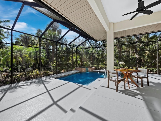 view of swimming pool featuring an in ground hot tub, ceiling fan, a patio area, and glass enclosure