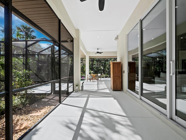 unfurnished sunroom featuring ceiling fan