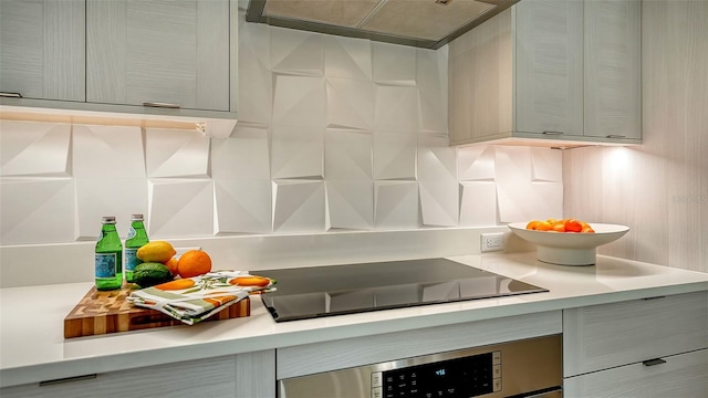 kitchen with gray cabinets, wall oven, black electric stovetop, and custom range hood