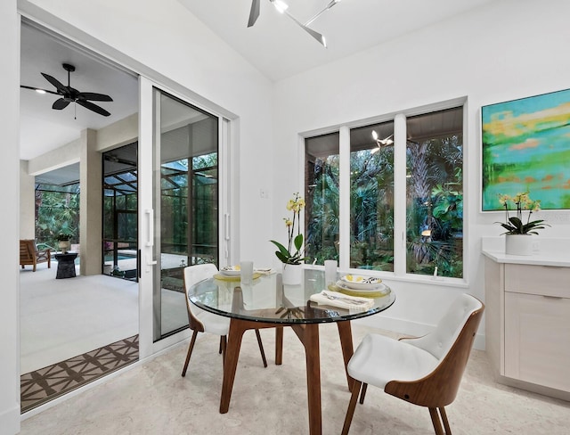sunroom featuring a ceiling fan and outdoor dining space