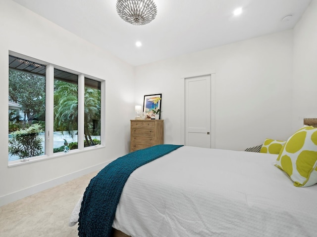 bedroom with recessed lighting, carpet flooring, baseboards, and multiple windows