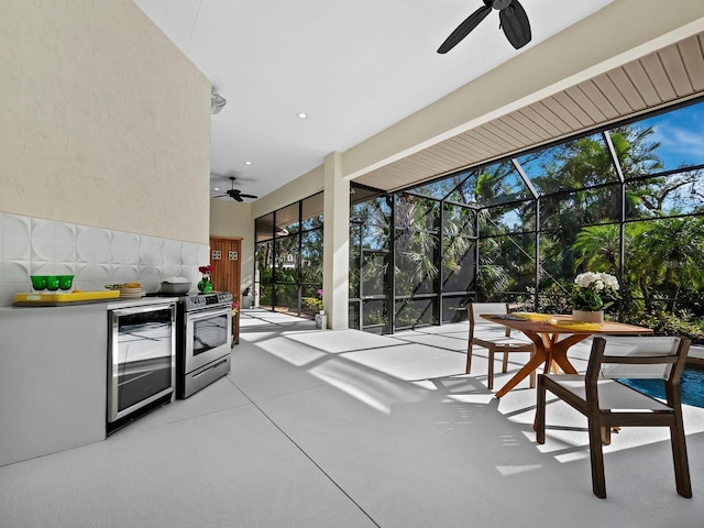 interior space with area for grilling, beverage cooler, glass enclosure, outdoor dining space, and ceiling fan