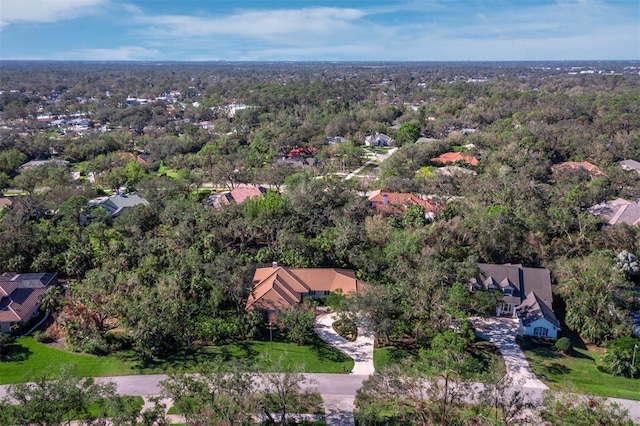 birds eye view of property featuring a wooded view and a residential view