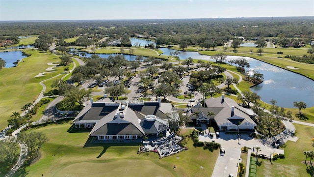 aerial view with golf course view and a water view