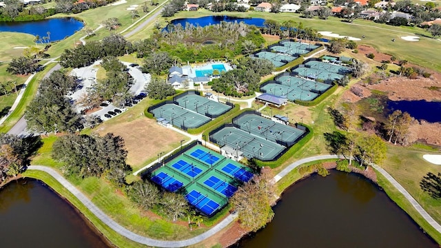 birds eye view of property featuring view of golf course, a water view, and a residential view