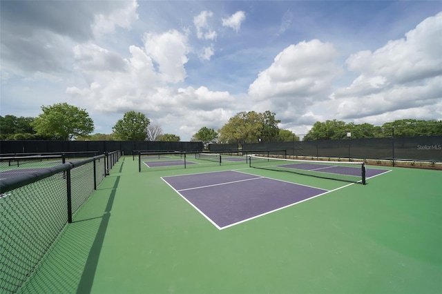view of tennis court featuring fence