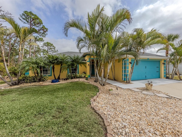 view of front of house with a garage and a front yard