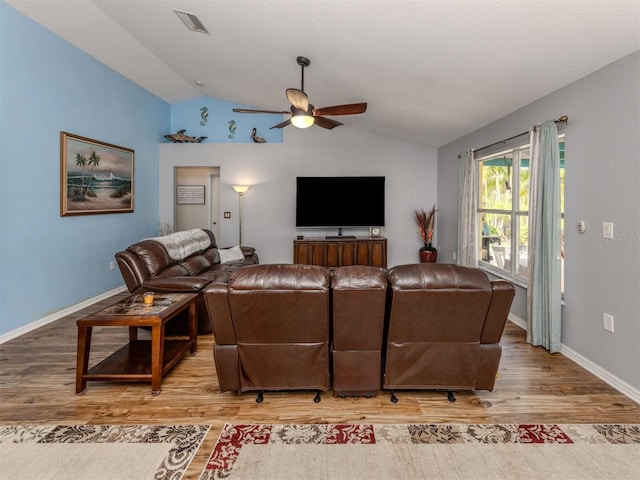 living room with light wood-type flooring, vaulted ceiling, and ceiling fan