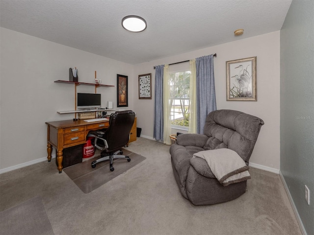 home office featuring a textured ceiling and light carpet