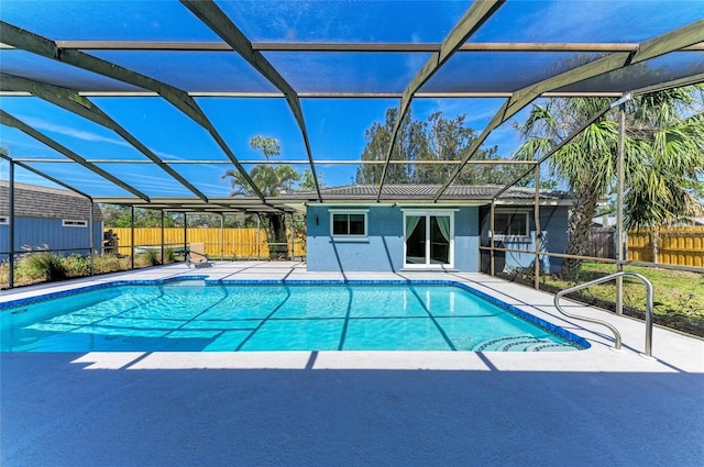 view of pool featuring glass enclosure, a patio area, fence, and a fenced in pool