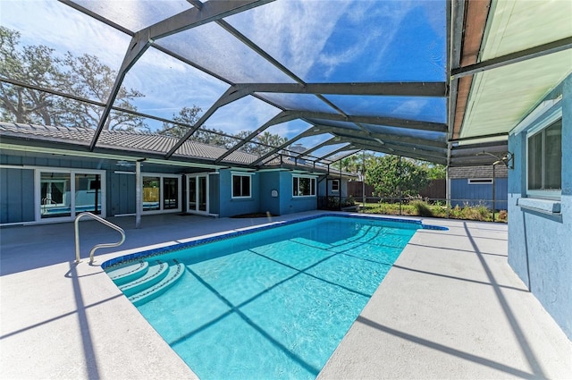 outdoor pool featuring a patio area and glass enclosure