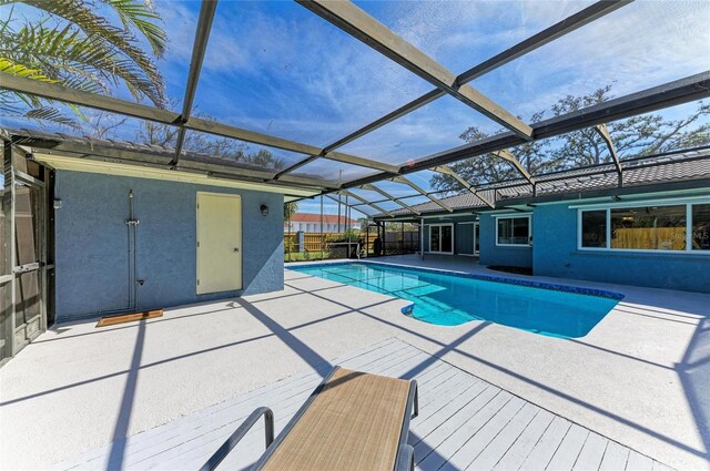 outdoor pool with a lanai and a patio