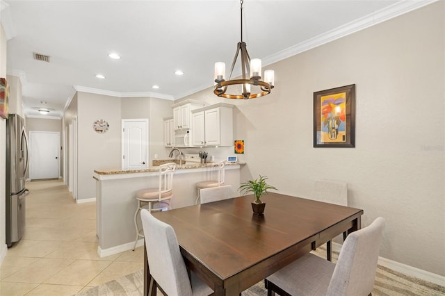 tiled dining room with crown molding and a notable chandelier