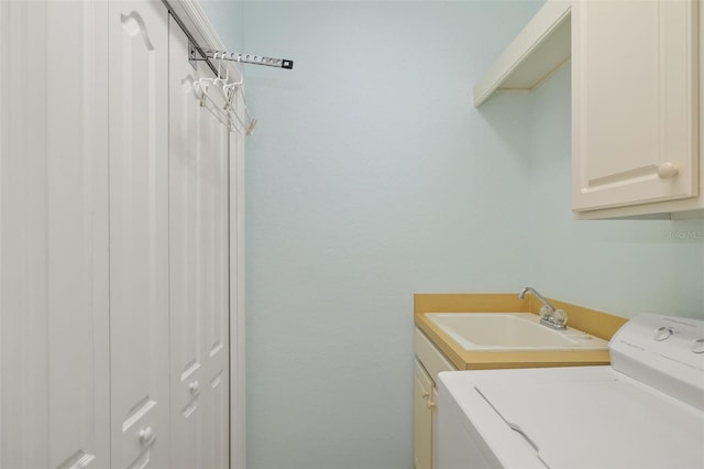 washroom featuring washer / clothes dryer, sink, and cabinets