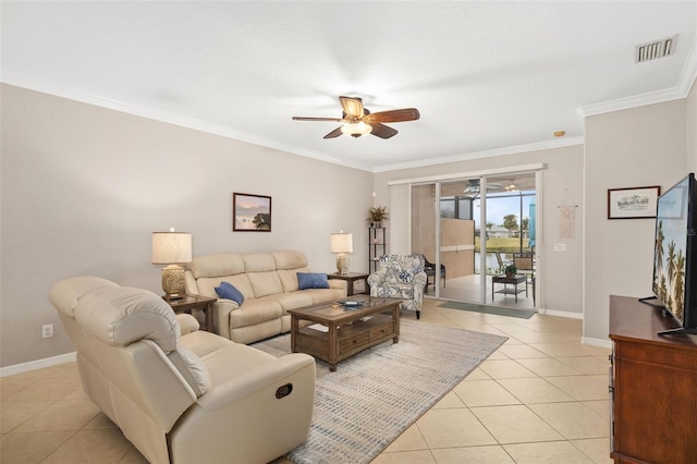 living area with light tile patterned floors, visible vents, a ceiling fan, baseboards, and ornamental molding