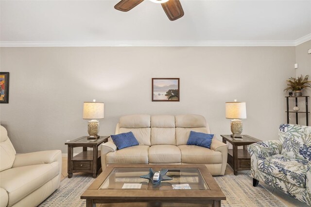 living room with ceiling fan, ornamental molding, and baseboards