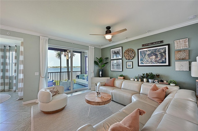 living room featuring ceiling fan, a water view, light tile patterned floors, and crown molding