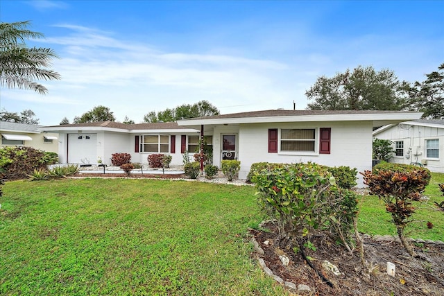 ranch-style house featuring a front yard and a garage