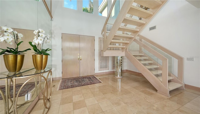 foyer with a towering ceiling