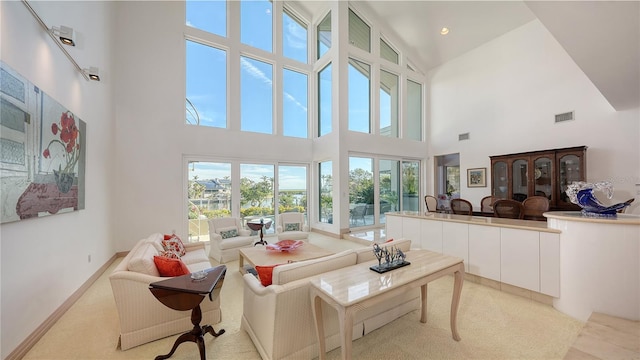 carpeted living room featuring a high ceiling