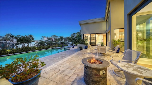 view of pool featuring a patio and a fire pit