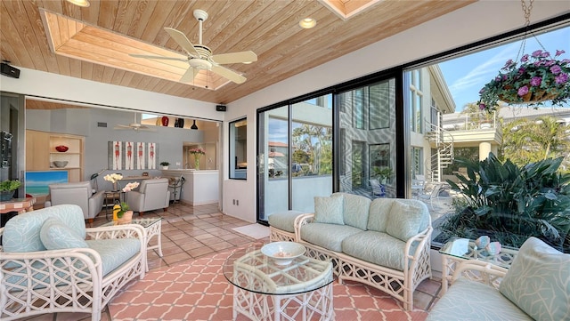 tiled living room featuring a skylight, wooden ceiling, and ceiling fan