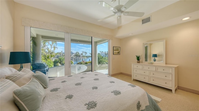 carpeted bedroom with a water view, access to outside, and ceiling fan