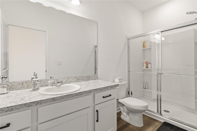 bathroom with toilet, walk in shower, and vanity