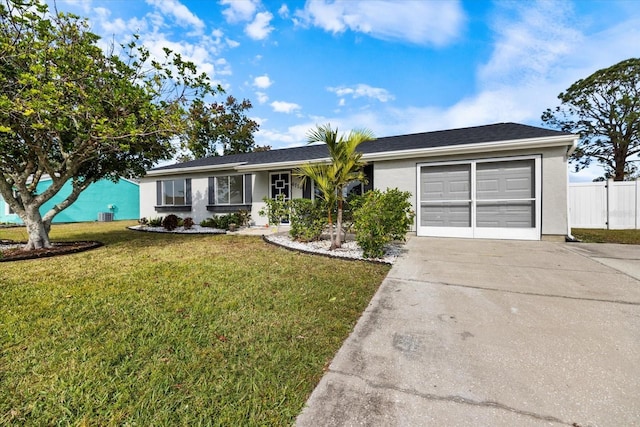 ranch-style home featuring a front yard, central AC, and a garage