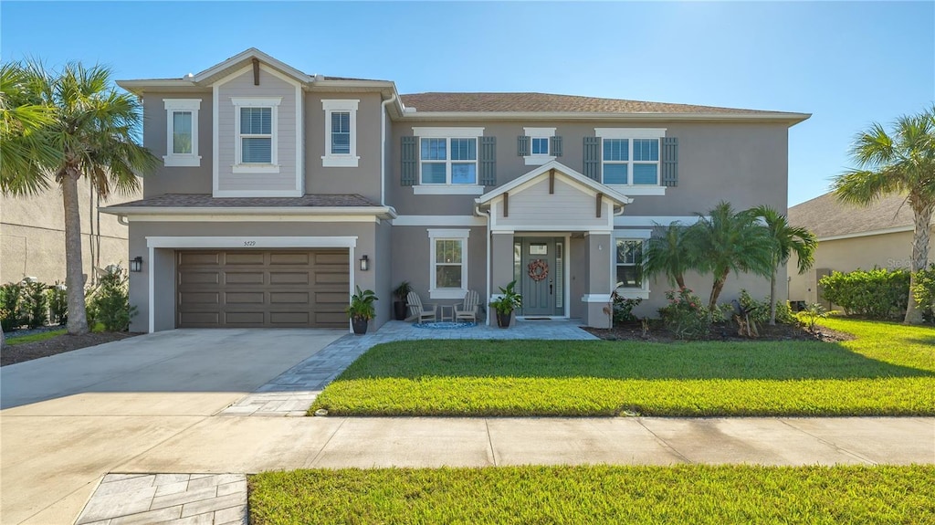 view of front of home with a front lawn and a garage