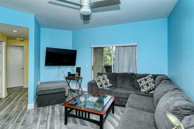 living room with hardwood / wood-style flooring and ceiling fan