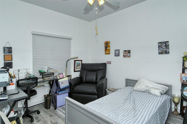 bedroom with light hardwood / wood-style floors and ceiling fan