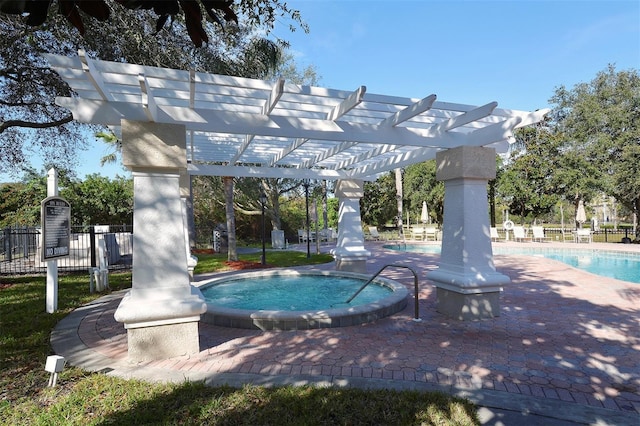 view of swimming pool featuring a community hot tub and a pergola