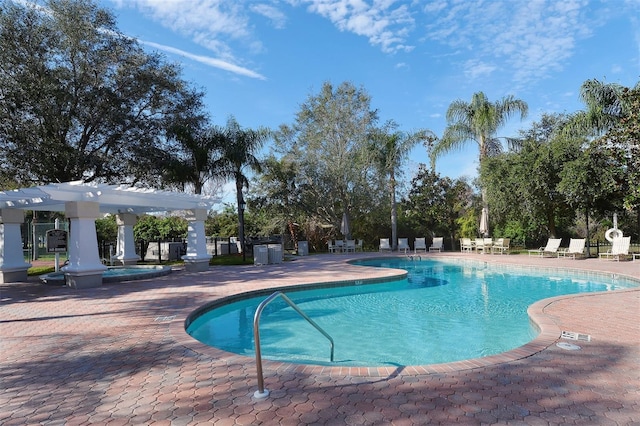 view of swimming pool with a patio area and a pergola