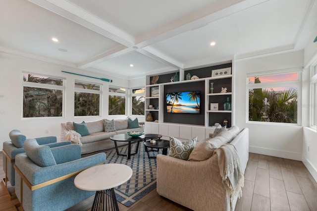 living room featuring beamed ceiling, crown molding, and hardwood / wood-style flooring