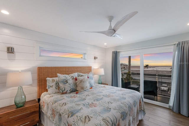 bedroom featuring ceiling fan, access to exterior, and dark hardwood / wood-style flooring