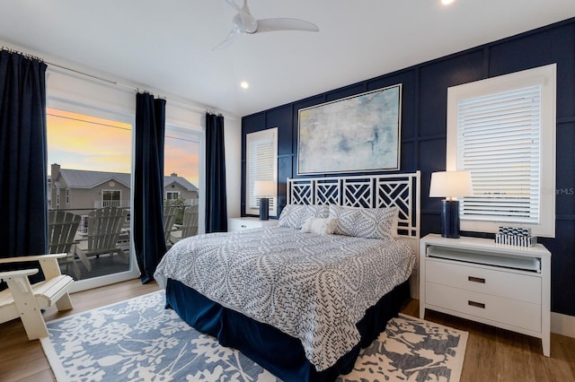 bedroom with ceiling fan, access to exterior, and hardwood / wood-style flooring