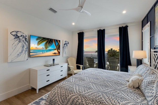 bedroom with ceiling fan, access to exterior, and hardwood / wood-style floors