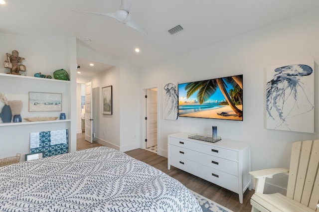 bedroom with ceiling fan, dark hardwood / wood-style floors, and ensuite bath