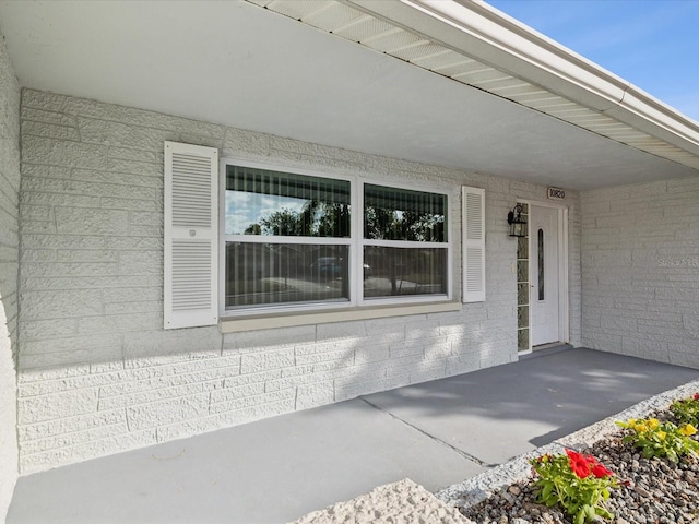 view of exterior entry featuring a patio