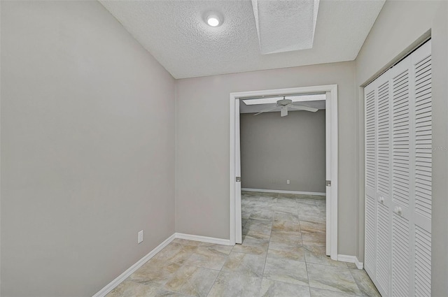 hall featuring a textured ceiling