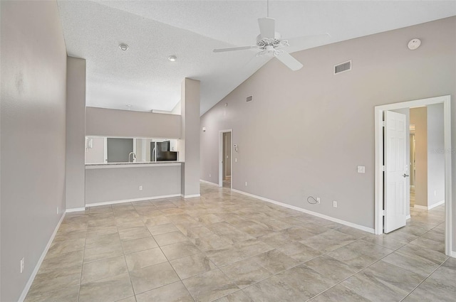 unfurnished living room with high vaulted ceiling, a textured ceiling, and ceiling fan