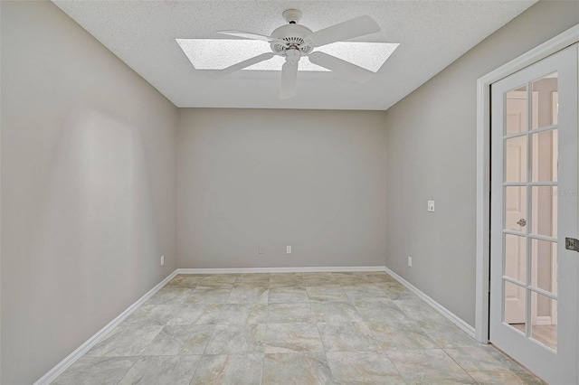 unfurnished room featuring ceiling fan, a textured ceiling, and french doors