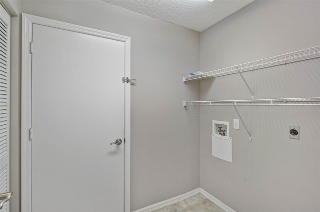 clothes washing area with washer hookup, hookup for an electric dryer, and a textured ceiling