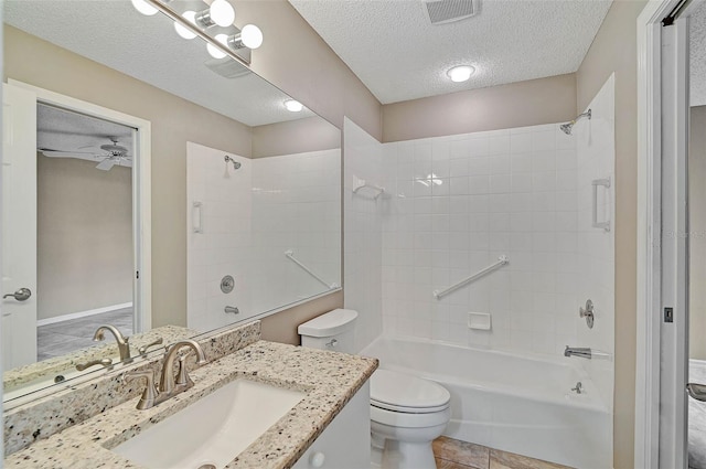 full bathroom featuring toilet, ceiling fan,  shower combination, a textured ceiling, and vanity