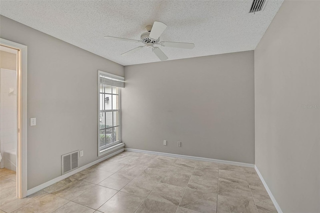 unfurnished room featuring ceiling fan, a textured ceiling, and light tile patterned floors