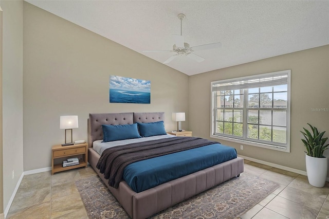 bedroom featuring ceiling fan, a textured ceiling, light tile patterned floors, and lofted ceiling