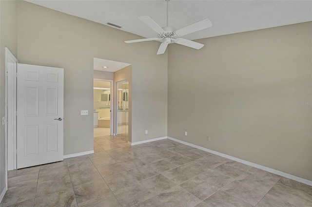 spare room with ceiling fan and light tile patterned flooring